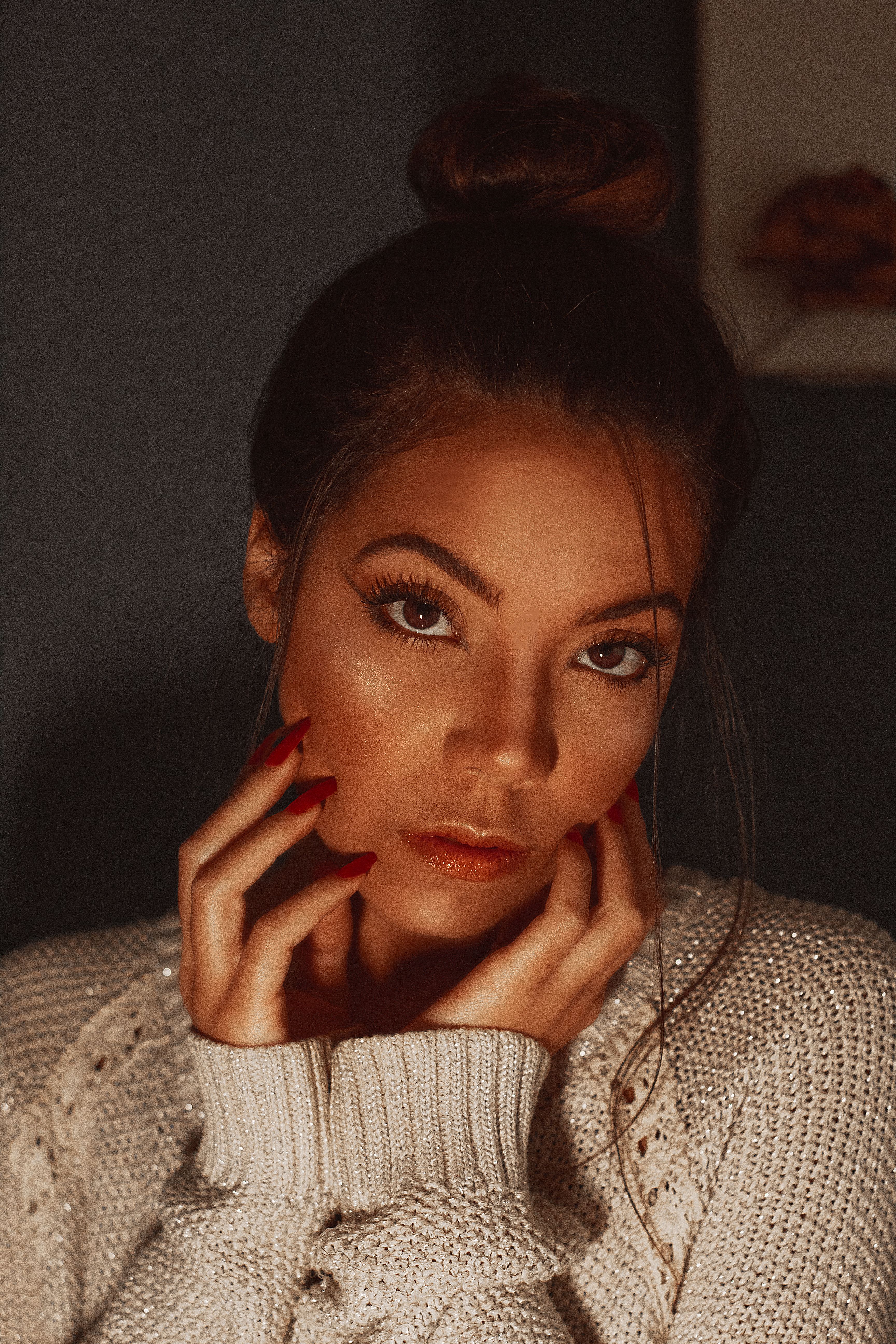 Editorial portrait with a glossy red manicure, photographed by Becca Correia
